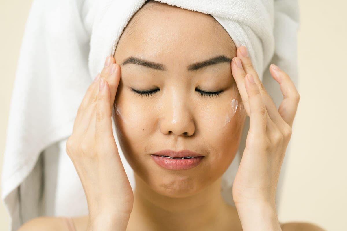 Fragrance-free mineral face sunscreen on a plain bathroom shelf