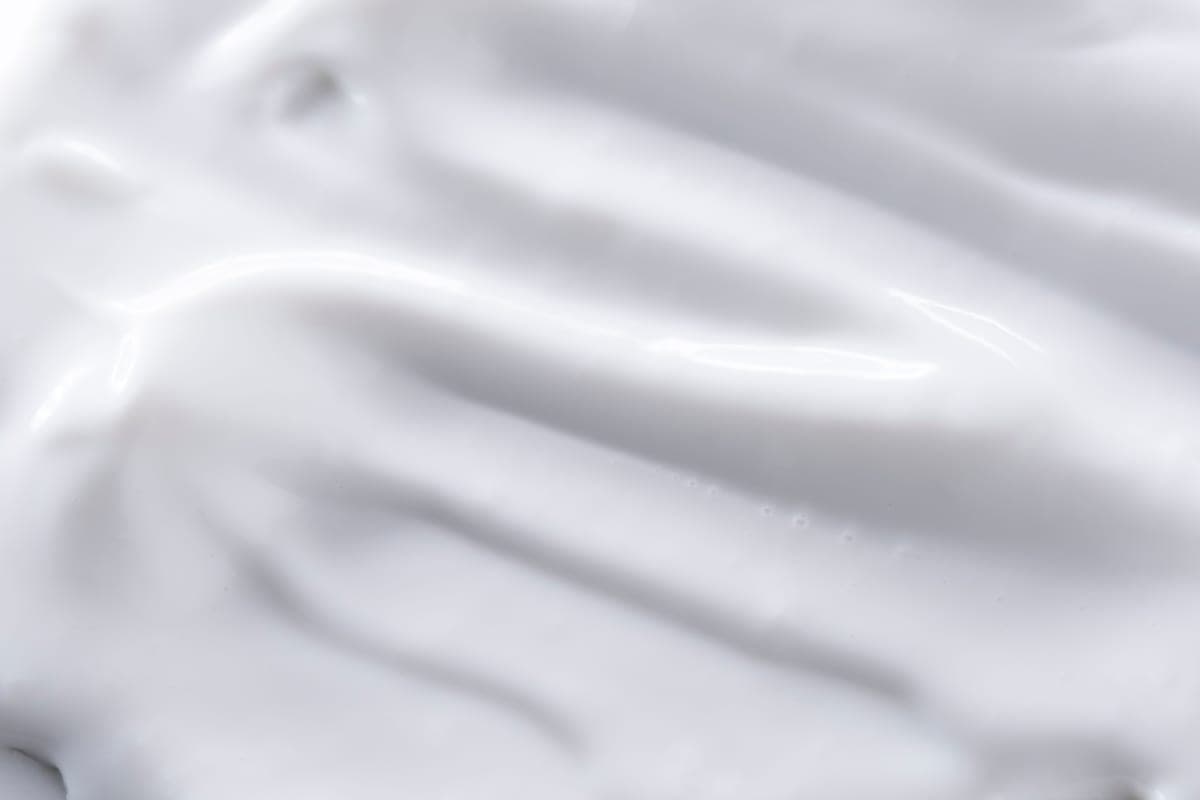 Close view of thick zinc sunscreen textured on a fingertip