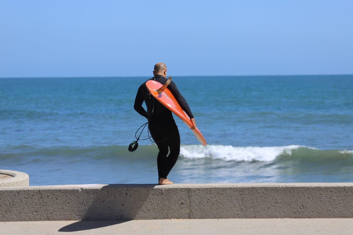 A close-fitting rash guard and a looser swim shirt laid out together