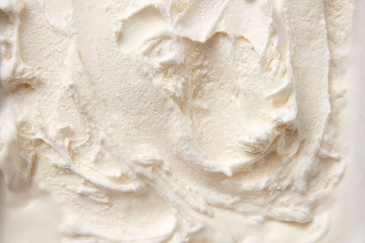 Thick mineral sunscreen cream squeezed from a tube onto a hand
