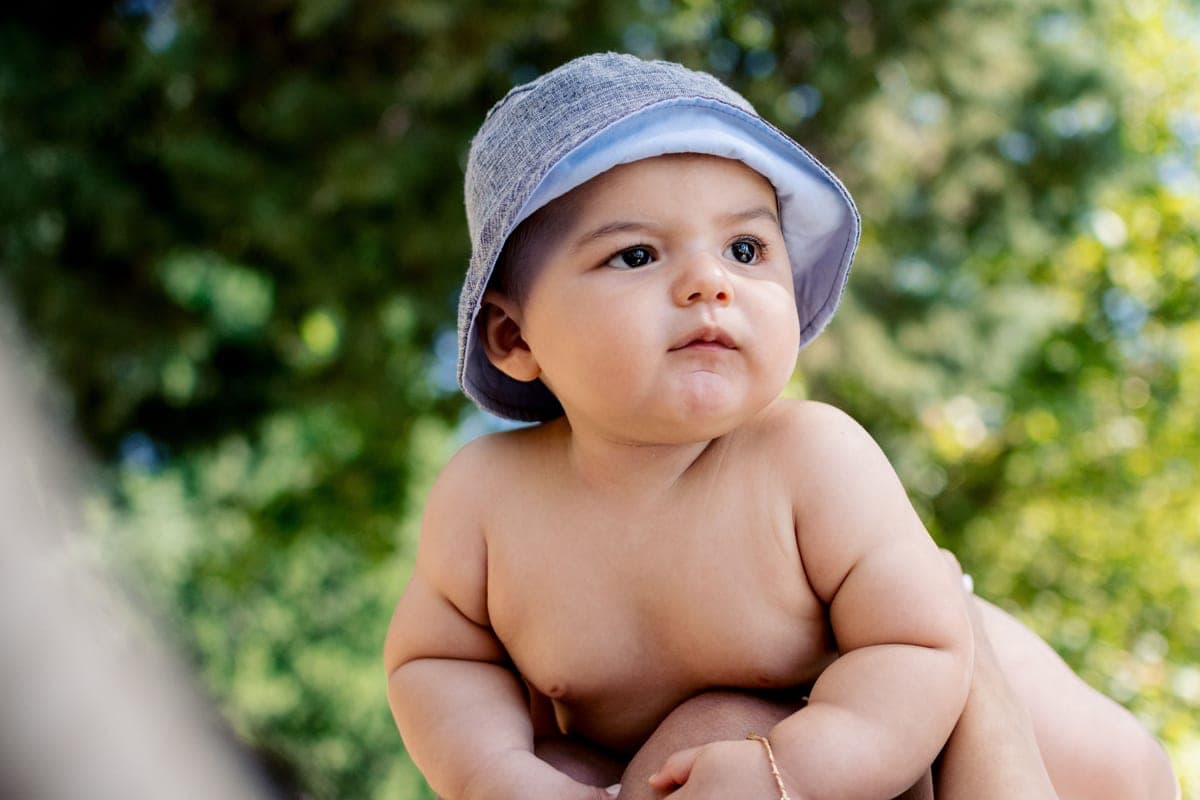 Sun hat and shade canopy packed beside a stroller