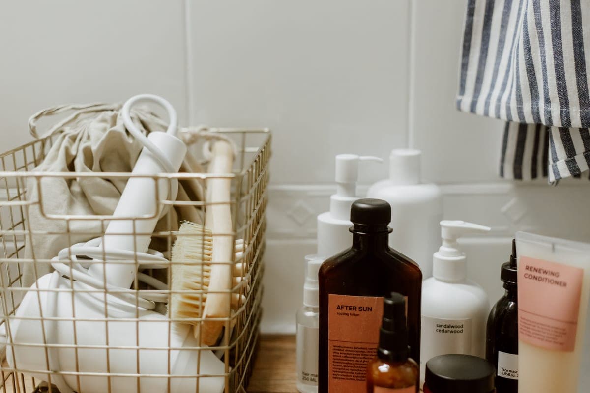 Morning skincare products lined up beside a sunscreen tube