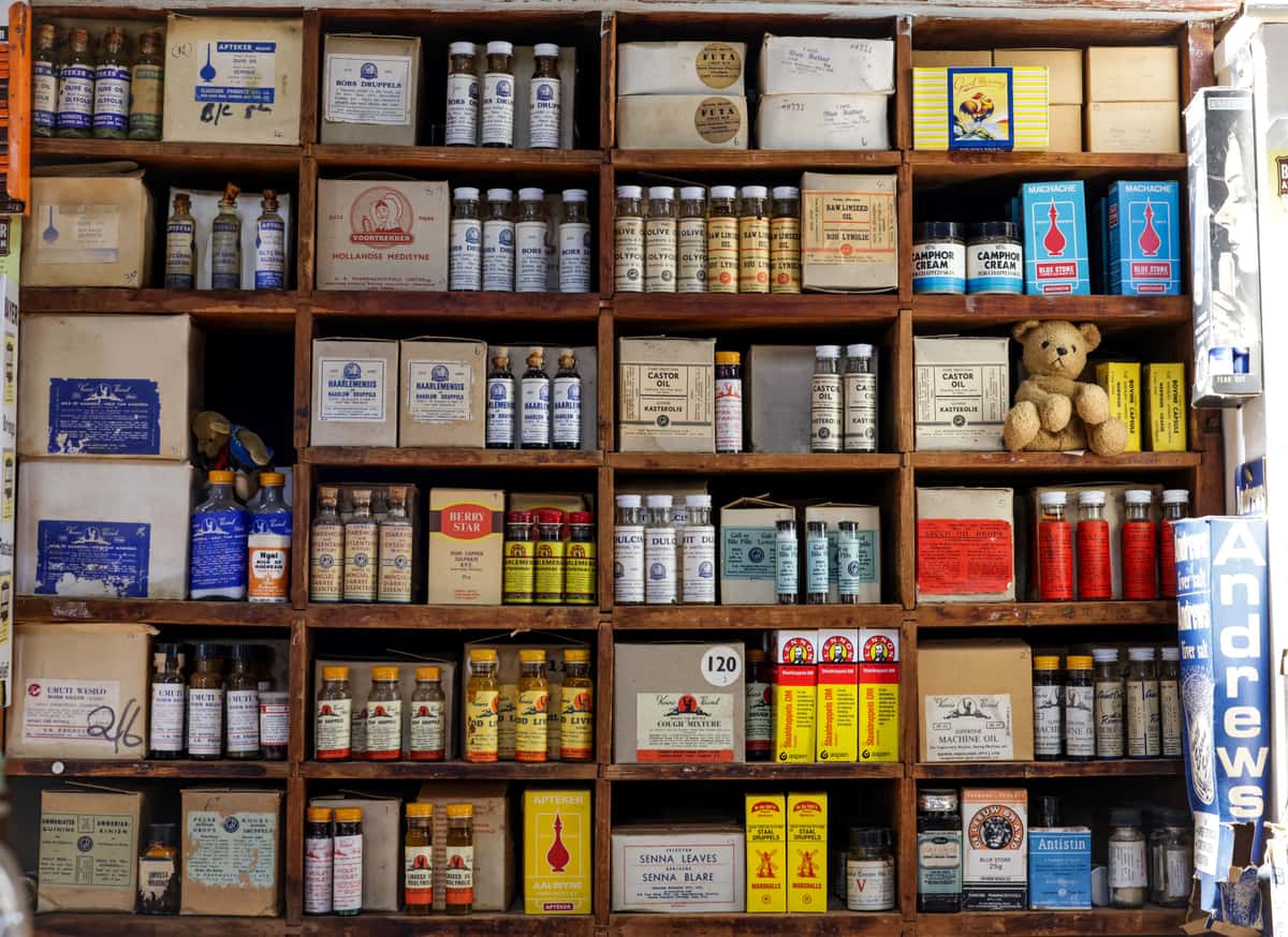Sunscreen bottles with botanical packaging arranged on a wooden surface