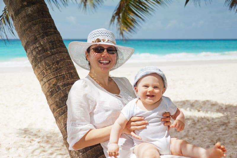 Baby mineral sunscreen bottle on a shaded blanket