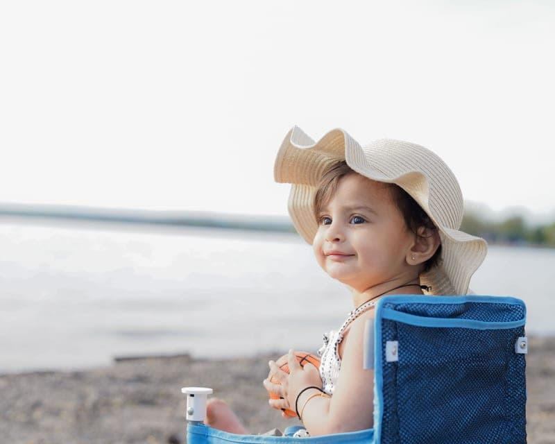 Baby mineral sunscreen tube tucked into a stroller seat