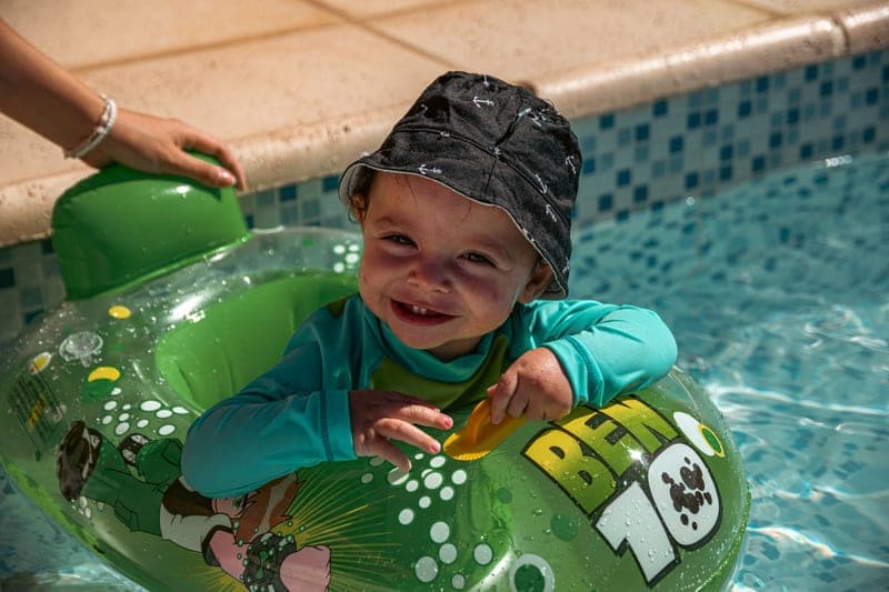 Toddler in a wide-brim bucket hat with a chin strap