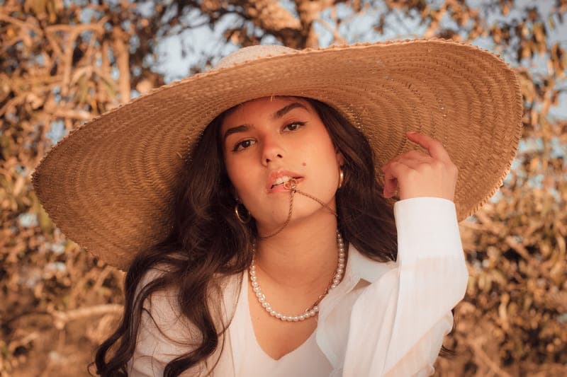 Packable wide-brim sun hat resting on a beach bag